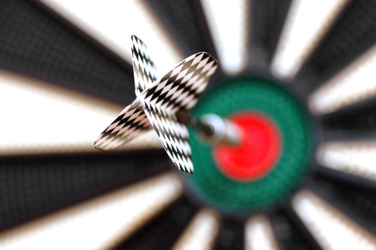 One arrow in the centre of a dart board Image description